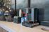 Elegant coffee station equipped with a modern Keurig machine, stylish sugar containers, and contemporary decor.