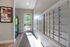Bright and welcoming apartment entrance featuring secure mailboxes, a bulletin board with community notices, and a modern vending machine.