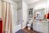 Bright and modern bathroom featuring granite countertops, elegant fixtures, and vibrant decor.