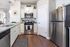 Modern kitchen with stainless steel appliances, stylish white cabinetry, and elegant granite countertops.