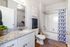 Elegant bathroom with granite countertop, stylish decor, and modern shower in a spacious apartment.