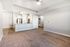 Modern open-plan apartment featuring a sleek kitchen with stainless steel appliances and a spacious living area with cozy carpet flooring.