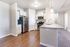 Modern kitchen with sleek stainless steel appliances, granite countertops, and elegant pendant lighting over a spacious breakfast bar.