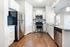 Contemporary kitchen with sleek stainless steel appliances, elegant granite countertops, and stylish white cabinetry.