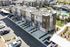 Modern apartment complex with sleek townhouses, pristine driveways, and lush landscaping. Enjoy luxury living with nearby resort-style pool and recreational spaces.