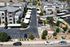 Modern apartment complex with lush greenery, ample parking, and recreational spaces, offering a vibrant community living experience.