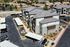 Aerial view of modern apartment complex with well-maintained landscaping and ample parking spaces under covered carports.