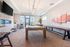 Contemporary recreational room with elegant pool table, stylish seating, and panoramic window views, perfect for entertaining.