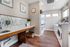 Bright and modern laundry room featuring sleek washing machines, contemporary decor, and stylish wood flooring.
