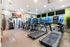 Modern fitness center with state-of-the-art treadmills, stair climber, and exercise equipment in a bright and inviting space.