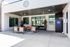 Inviting outdoor lounge area with modern seating, ceiling fans, and a convenient vending machine under a stylish covered patio.