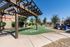 Charming outdoor space with a wooden pergola, lush greenery, and a scenic view, perfect for relaxation.