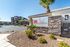 Inviting entrance to Grayhawk Apartments at River's Edge, surrounded by well-maintained landscaping and modern architecture.