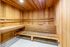 Luxurious sauna with elegant wood paneling and comfortable seating, perfect for relaxation and wellness.