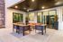 Modern outdoor patio with elegant seating area and stylish lighting, ideal for relaxed gatherings.