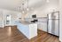 Bright and modern kitchen featuring sleek granite countertops, stainless steel appliances, and stylish pendant lighting.