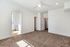 Bright and spacious bedroom with plush carpeting, ceiling fan, and an ensuite bathroom featuring modern fixtures.