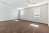 Spacious and bright room with plush carpeting and modern ceiling fans, perfect for a cozy living area or master bedroom.