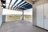 Inviting balcony with scenic mountain and valley views, featuring a modern railing and partially covered pergola.