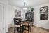 Elegant dining area with modern decor, featuring a stylish round table set for four under a chic chandelier.