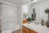Inviting bathroom with modern fixtures, elegant decor, and a fresh ambiance, featuring a spacious vanity and relaxing bathtub.