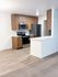 A beautifully updated kitchen featuring stainless steel appliances, wood-grain cabinetry, and expansive counter space.