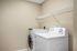 Modern laundry room equipped with sleek washer and dryer, featuring convenient wall-mounted shelving for optimal storage.