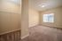 Bright and inviting bedroom with plush carpet, a spacious walk-in closet, and large window for ample natural light.