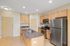 Modern kitchen with sleek stainless steel appliances, granite countertops, and warm wooden cabinetry creating a welcoming atmosphere.