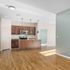 Bright open-concept kitchen with elegant wooden cabinets, modern stainless steel appliances, and stylish pendant lighting.