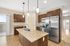 Sleek modern kitchen featuring granite countertops, stainless steel appliances, and elegant pendant lighting.