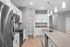 Modern kitchen with sleek stainless steel appliances, elegant pendant lighting, and spacious granite countertops.