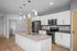 Modern kitchen design with sleek stainless steel appliances, elegant pendant lighting, and a spacious granite-topped island.