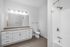 Modern bathroom with sleek fixtures, spacious vanity, and a bright airy design.
