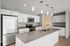 Modern kitchen with sleek stainless steel appliances, elegant white cabinetry, and a spacious granite island with pendant lighting.