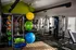 Modern fitness center with state-of-the-art gym equipment, vibrant yoga balls, and a sleek design, perfect for energizing workouts.