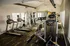 Modern fitness center with state-of-the-art equipment, including treadmills, weight machines, and free weights, in a bright, spacious setting.