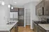 Modern kitchen with sleek stainless steel appliances, elegant granite countertops, and stylish mosaic backsplash.