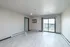 Bright and airy living room featuring sleek tile flooring, large sliding glass door, and modern finishes, opening to a beautiful balcony view.