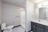 Modern bathroom with sleek gray cabinetry, spacious vanity, and a walk-in shower.
