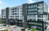 Modern apartment building featuring sleek balconies and a prime location with ground-floor shopping attractions.