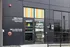 Chic urban building entrance showcasing colorful windows and signs for The Lights Event Center and apartment access.
