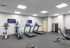 Modern fitness center equipped with treadmills, exercise bikes, and a variety of training equipment, ideal for a healthy lifestyle.