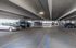 Spacious and well-lit parking garage with ample parking spots and clear signage for convenience.