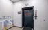 Modern elevator entrance in the stylish Envy Building, featuring a vibrant wall design and clear signage.