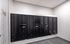Modern apartment mailroom showcasing sleek black mailboxes in an organized layout.