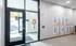 Inviting apartment entrance with modern glass door, stylish wall art saying 'Live at the Lights', and a welcoming ambiance.