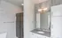 Contemporary bathroom with sleek glass shower, modern vanity, and stylish lighting.