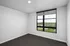 Bright and airy room with large window offering scenic views, perfect for a serene living experience.