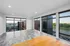 Expansive living space with panoramic floor-to-ceiling windows offering stunning city and greenery views.